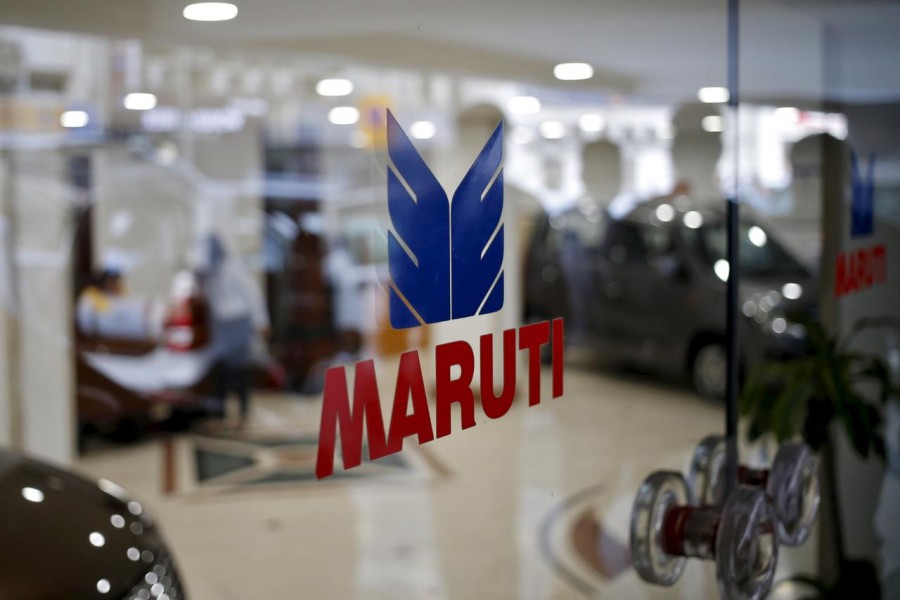 FILE PHOTO: The logo of Maruti Suzuki India Limited is seen on a glass door at a showroom in New Delhi, India, February 29, 2016. REUTERS/Anindito Mukherjee//File Photo