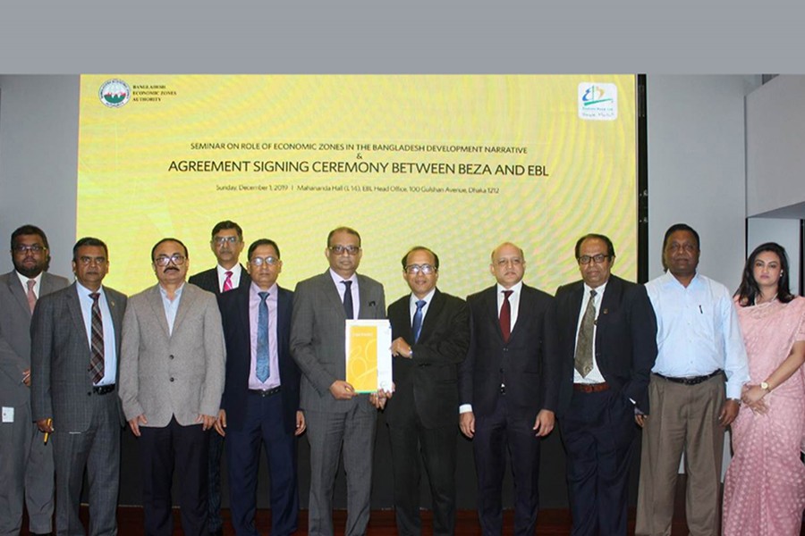 Ali Reza Iftekhar (sixth from left), managing director and CEO of EBL and Md Shoab, joint secretary and general manager (Admin and Finance) of BEZA seen exchanging documents of the agreement on behalf of their respective organisations