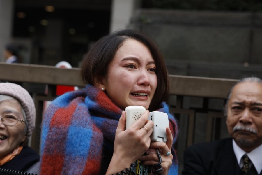 Freelance journalist Shiori Ito sheds tears while talking to her supporters outside a courthouse Wednesday, Dec. 18, 2019, in Tokyo. (AP Photo/Jae C. Hong)