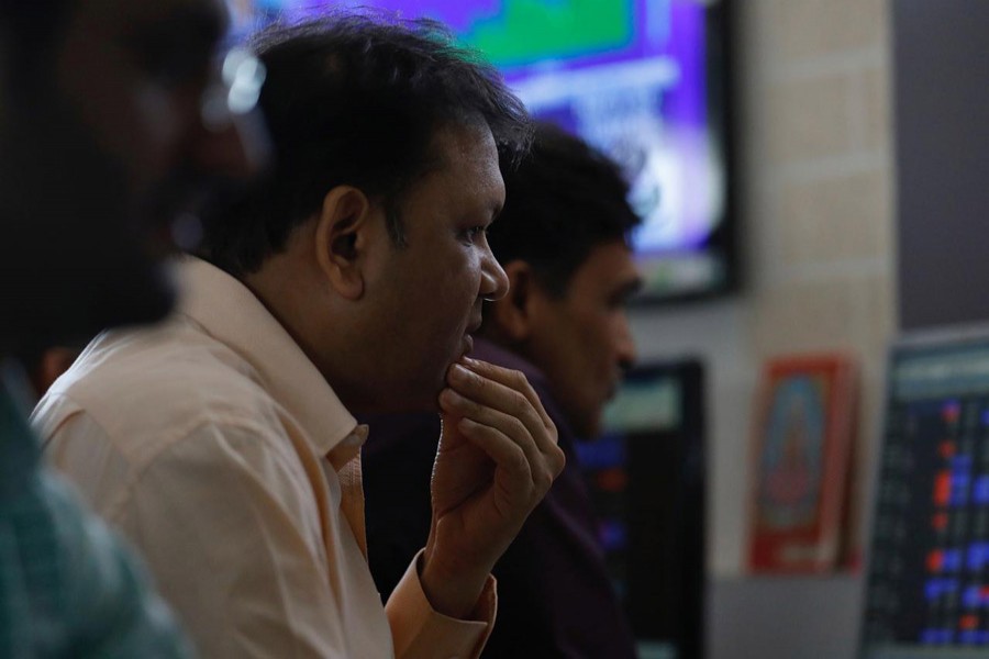 A broker reacts while trading at his computer terminal at a stock brokerage firm in Mumbai, December 28, 2017. Reuters/File Photo