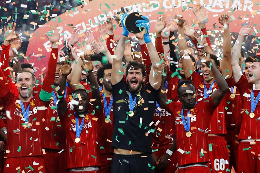 Liverpool's Alisson lifts the trophy as they celebrate after winning the Club World Cup — Reuters photo