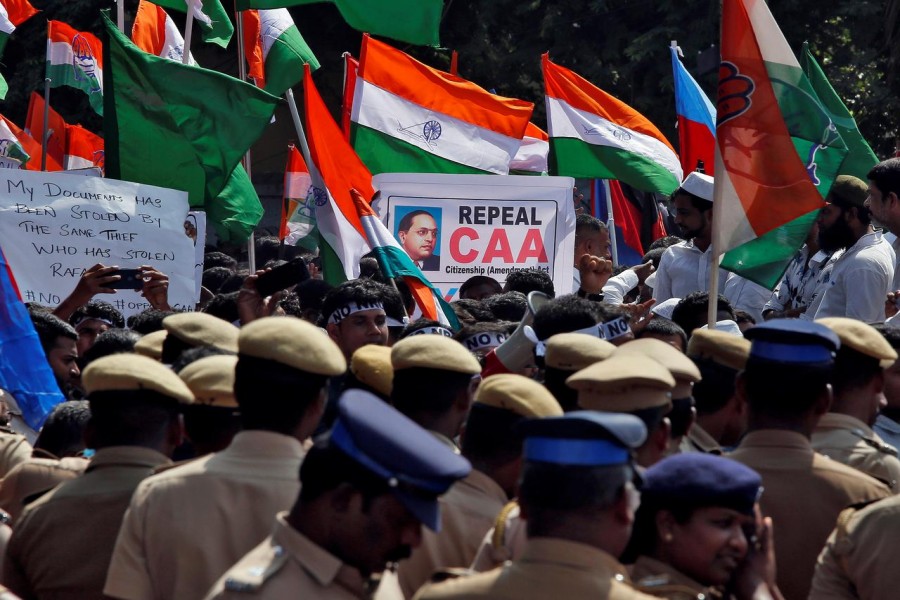 Police officers stand as demonstrators gather to attend a protest, organised by various political parties, against a new citizenship law, in Chennai, India, December 23, 2019. Reuters