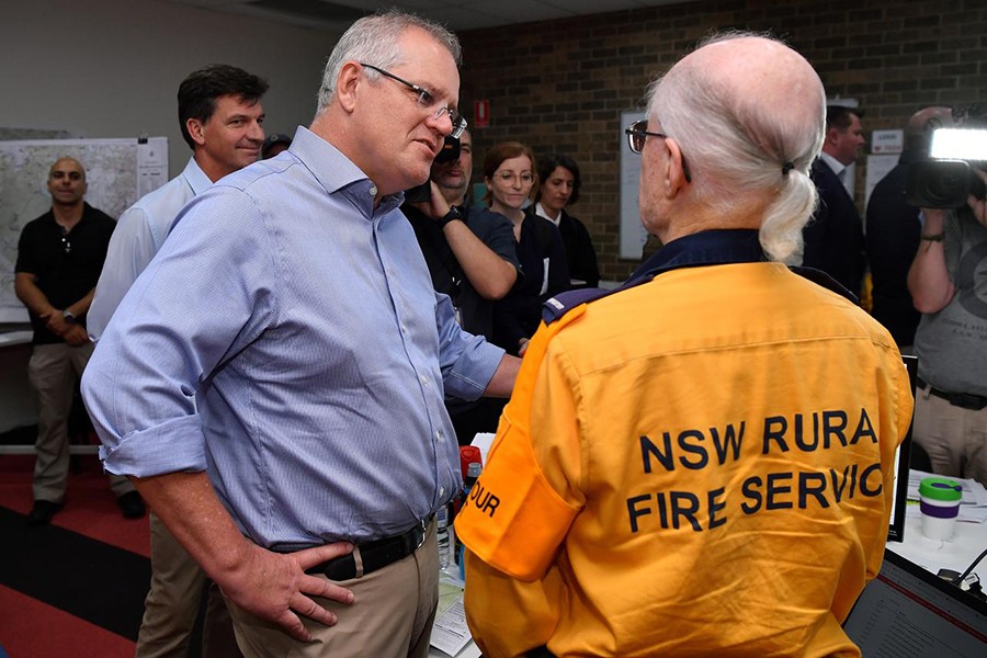 Australia's Prime Minister Scott Morrison greets a volunteer during a visit to the Wollondilly Emergency Control Centre in Sydney, Australia on December 22, 2019 — AAP Image via Reuters