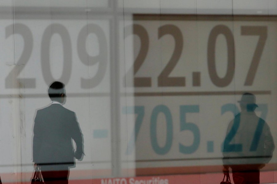 An investor looks at a stock quotation board at a brokerage office in Beijing, China, January 3, 2020. Reuters