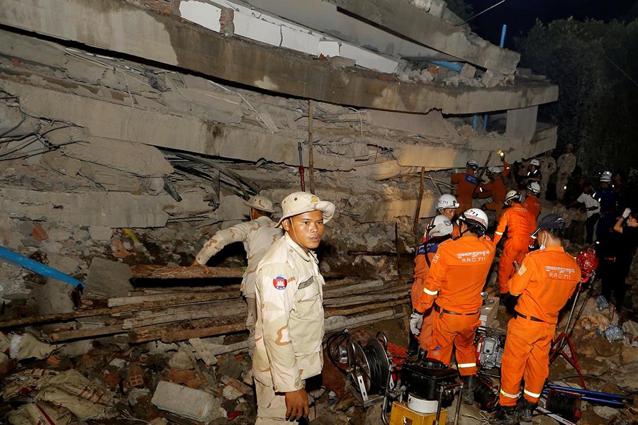 A rescue team searches for trapped workers at a collapsed building, which was under construction in Kep, Cambodia on January 3, 2020 — Reuters photo