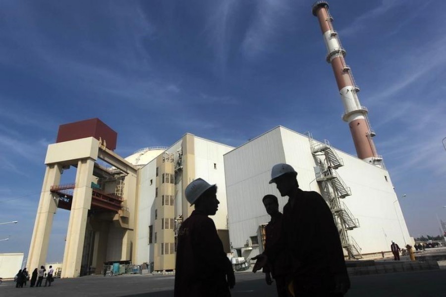 Iranian workers stand in front of the Bushehr nuclear power plant, about 1,200 km (746 miles) south of Tehran, October 26, 2010. Reuters/Mehr News Agency