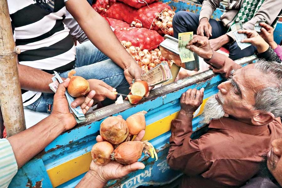 A consumer showing substandard onions, just sold at a subsidised rate of Tk 35 per kg from a TCB truck sale point near National Press Club in the capital on Sunday — FE Photo by Shafiqul Alam