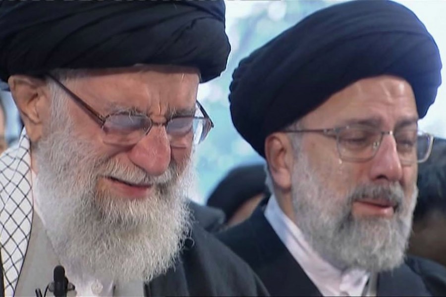 Iranian Supreme Leader Ayatollah Ali Khamenei, left, openly weeping as he leads a prayer over the coffin of Gen. Qassem Soleimani at the Tehran University campus, in Tehran on Monday. The image was taken from a video footage. -AP Photo