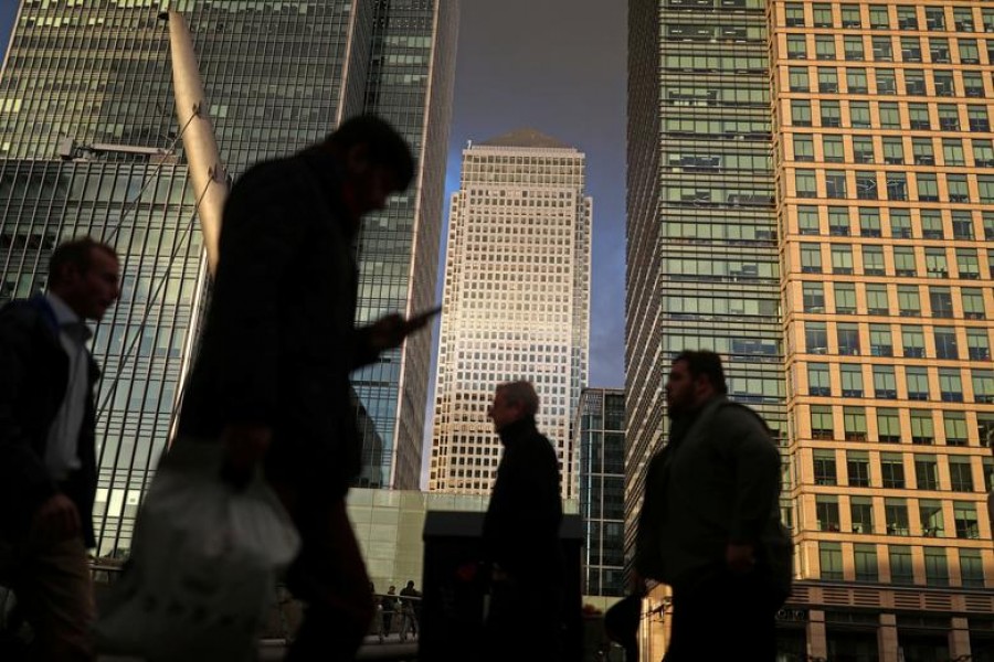 People walk through the Canary Wharf financial district of London, Britain, December 7, 2018. Reuters/File Photo