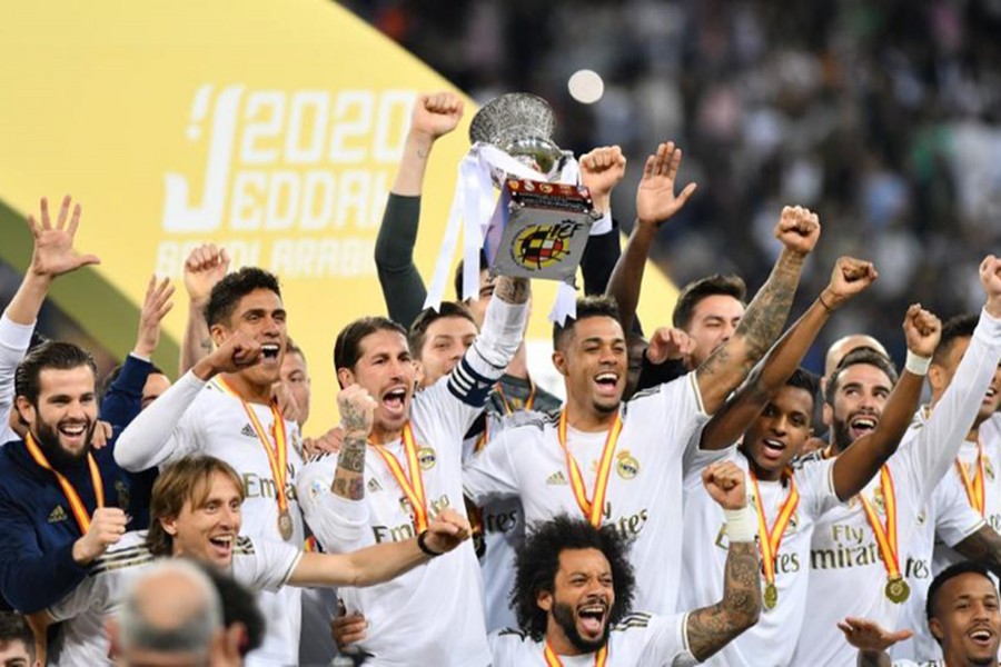 Sergio Ramos lifts the trophy as Real Madrid players celebrate winning the Spanish Super Cup — Reuters photo