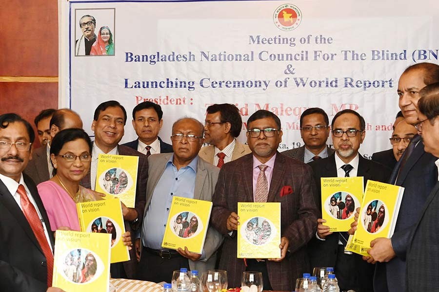 Health Minister Zahid Maleque unveiling the cover of a report, titled World Report on Vision, at a city hotel on Sunday. -PID Photo