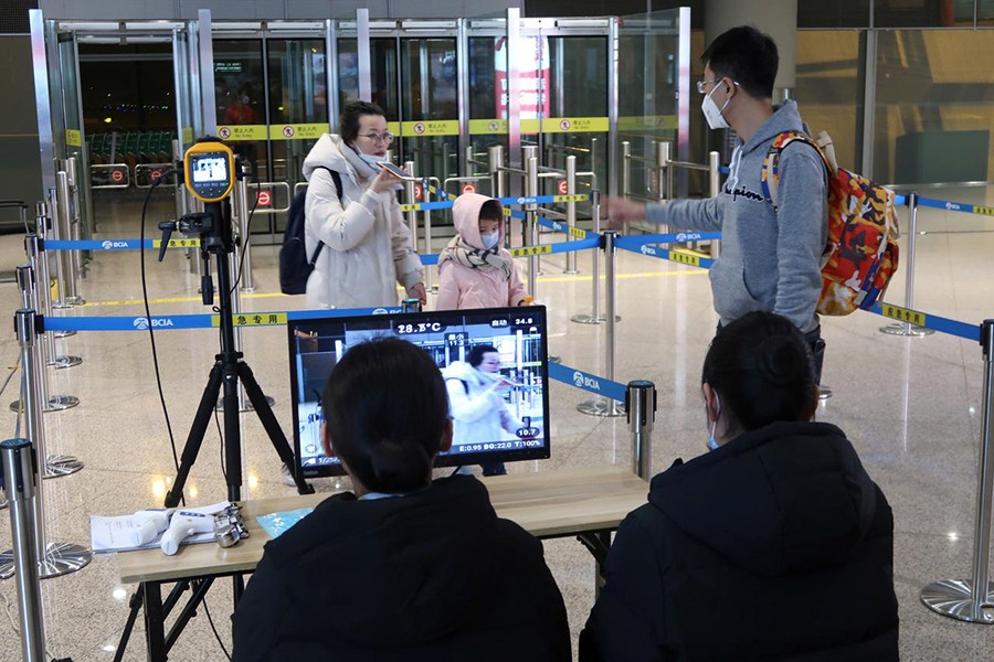 Staff members monitor thermal scanners that detect temperatures of passengers who have just landed at the arrival terminal in Beijing Capital International Airport in Beijing, China on January 25, 2020 — Reuters photo