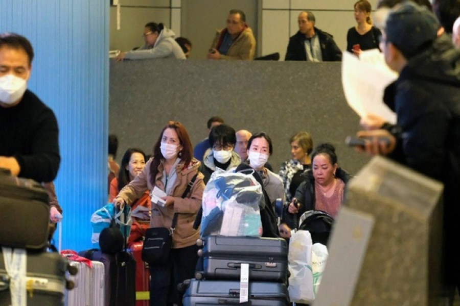 Passengers arrive at LAX from Shanghai, China, after a positive case of the coronavirus was announced in the Orange County suburb of Los Angeles, California, US, January 26, 2020. Reuters