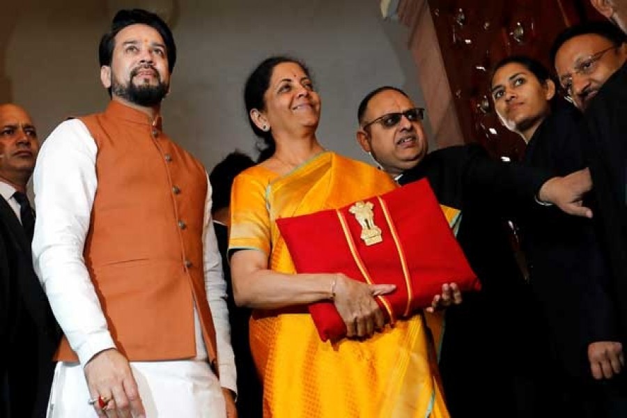 India's finance minister Nirmala Sitharaman is flanked by junior Finance Minister Anurag Thakur as she arrives to present the budget in Parliament in New Delhi, India, February 01, 2020. Reuters