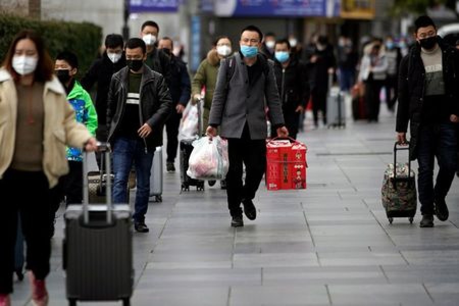 Passengers wearing masks walk outside the Shanghai railway station in Shanghai, China, as the country is hit by an outbreak of a new coronavirus, February 2, 2020. Reuters