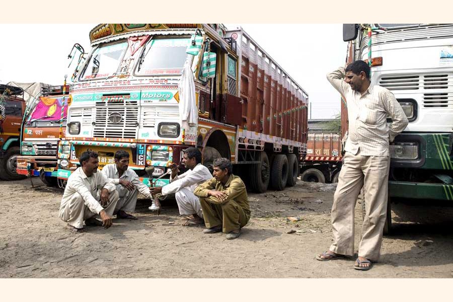 Indian truck drivers waiting at the Benapole Land Port truck terminal for their turn to unload the goods. The photo was taken on Monday     	— FE Photo