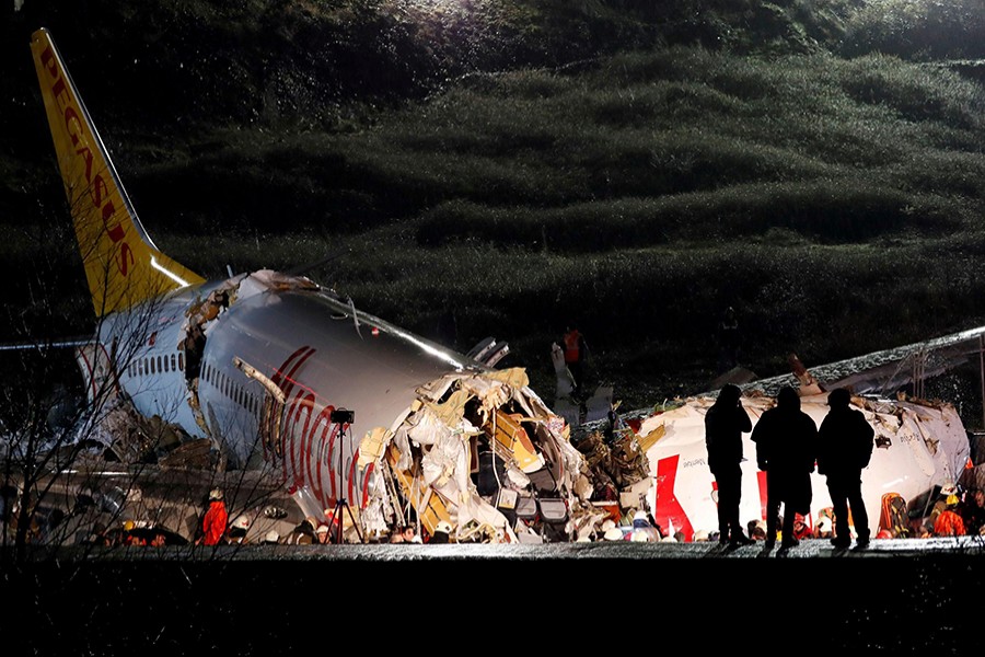 Police officers inspect the Pegasus Airlines Boeing 737-86J plane, that overran the runway during landing and crashed, at Istanbul’s Sabiha Gokcen airport, Turkey on February 5, 2020 — Reuters photo