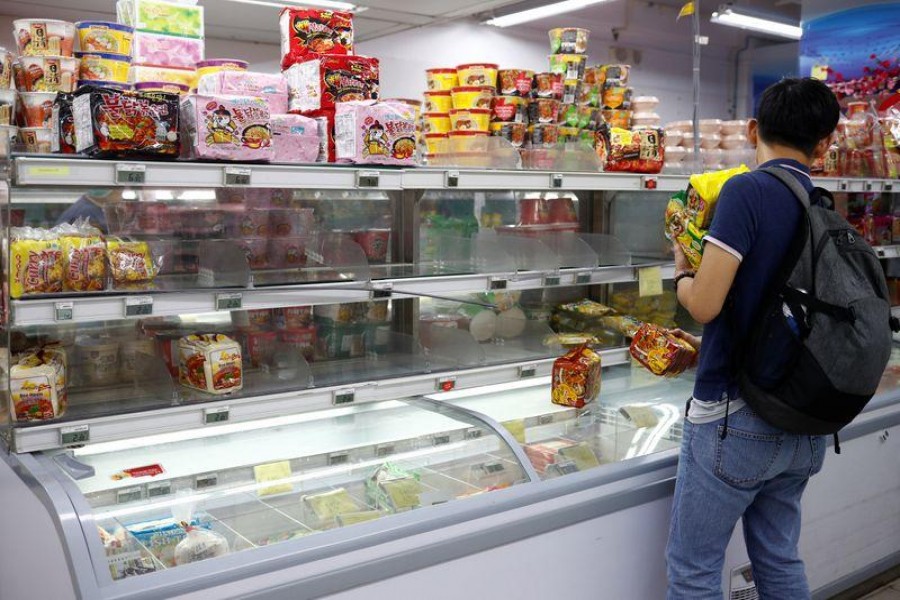 People stock up on food supplies after Singapore raised coronavirus outbreak alert to orange, at a supermarket in Singapore February 7, 2020. REUTERS/Edgar Su