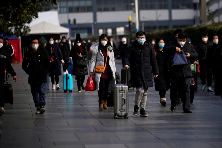 Passengers wearing masks walk at the Shanghai railway station in China, as the country is hit by an outbreak of the novel coronavirus, February 9, 2020. Reuters