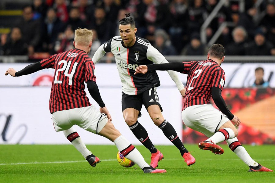 Juventus' Cristiano Ronaldo in action with AC Milan's Davide Calabria and Simon Kjaer — Reuters photo