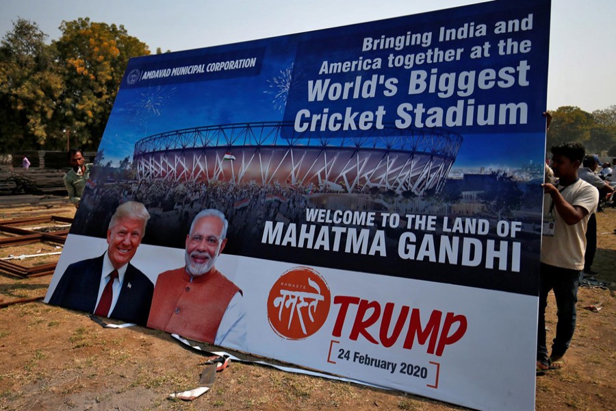 Workers prepare a hoarding with the images of the US president Donald Trump and India's prime minister Narendra Modi ahead of Trump's visit, on the outskirts of Ahmedabad, India, February 19, 2020. Reuters
