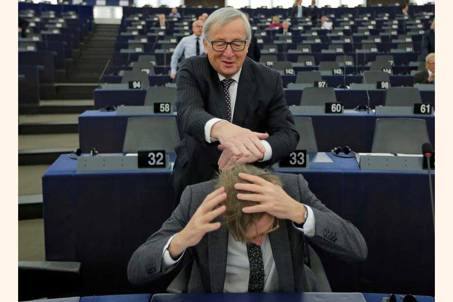 European Commission President Jean-Claude Juncker jokes with European Union's chief Brexit negotiator Guy Verhofstadt ahead of a debate on the Future of Europe at the European Parliament in Strasbourg, France on February 06, 2018.        —Reuters