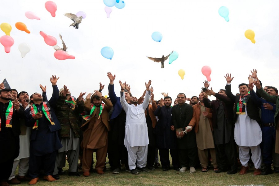 Afghan men celebrate in anticipation of the U.S-Taliban agreement to allow a U.S. troop reduction and a permanent ceasefire, in Jalalabad, Afghanistan February 28, 2020. REUTERS/Parwiz