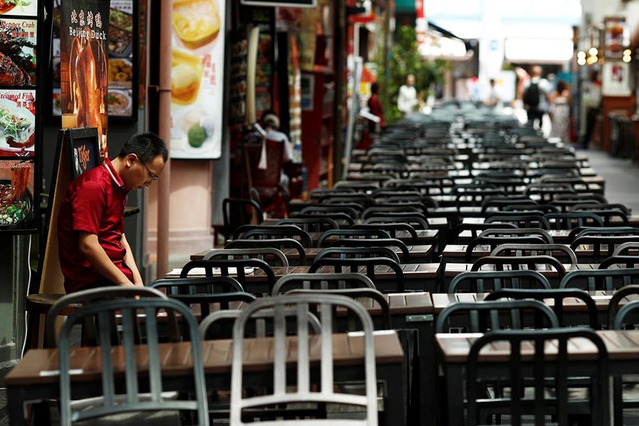 A restaurant promoter waiting for customers at the largely empty Chinatown as tourism takes a decline due to the coronavirus outbreak in Singapore. The photo was taken on February 21. -Reuters Photo