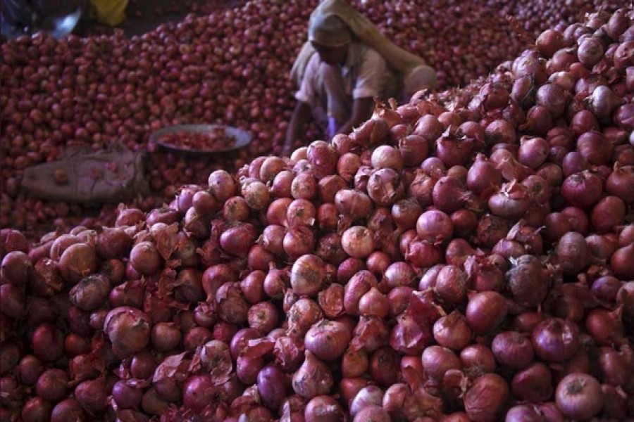 A worker sorts onions at a wholesale vegetable market in Chandigarh, India, July 24, 2015 —   Reuters/Files