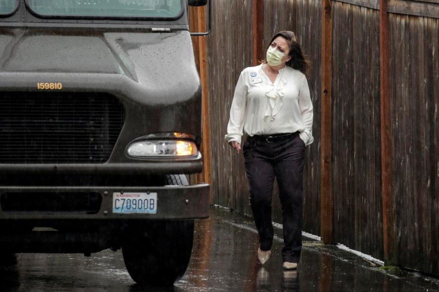 An employee looks at a UPS delivery truck at the Life Care Center of Kirkland, the long-term care facility linked to several confirmed coronavirus cases in the state, in Kirkland, Washington, US, March 02, 2020 — Reuters