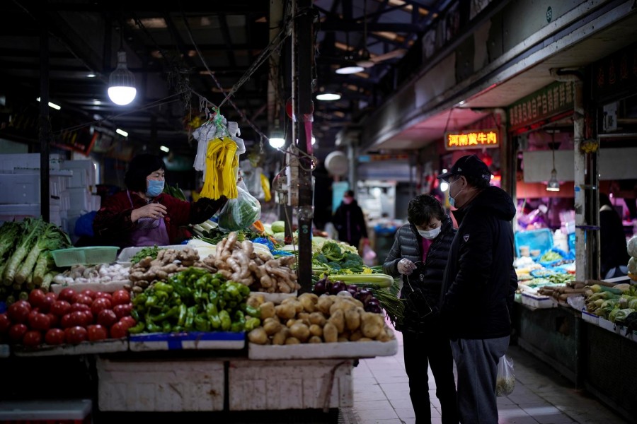 A vegetable stall owner wearing a face mask is seen at a market as the country is hit by an outbreak of the novel coronavirus, in Shanghai, China, March 3, 2020 — Reuters/Files