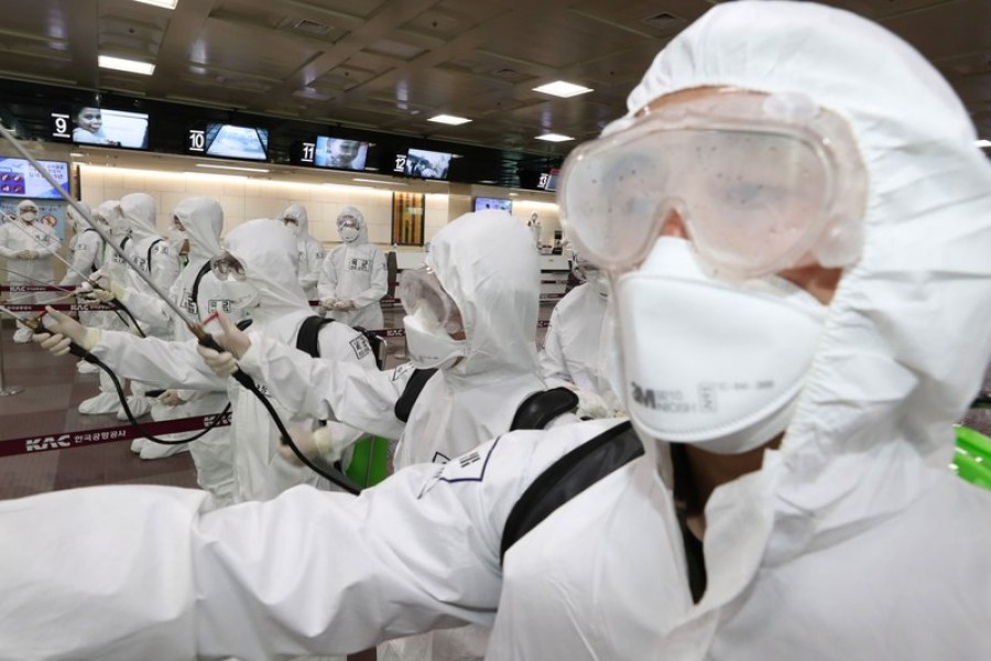 South Korean army soldiers wearing protective suits spray disinfectant to prevent the spread of the new coronavirus at Daegu International Airport in Daegu, South Korea, Friday, March 6, 2020 — AP Photo