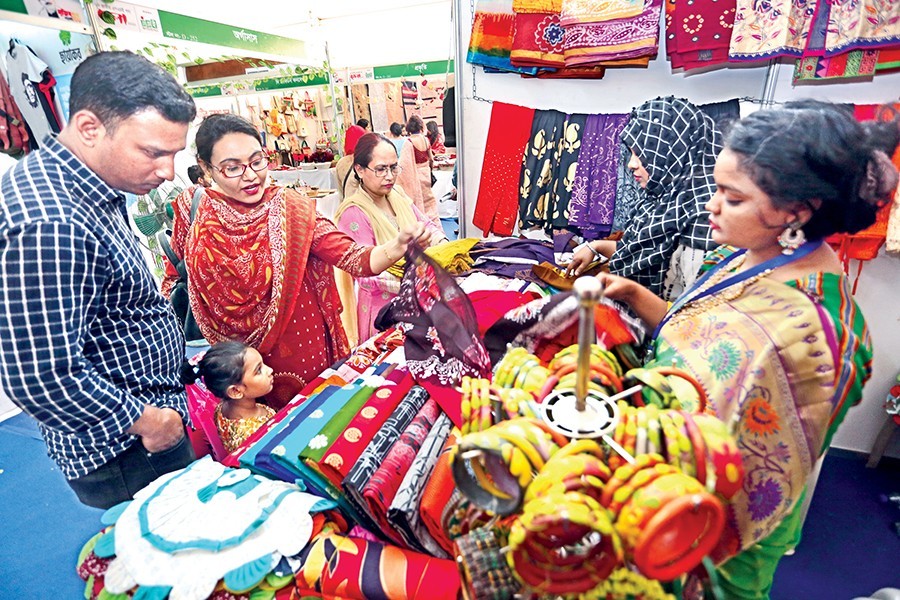 Visitors at a stall at the National SME Product Fair at Bangabandhu International Conference Centre in the city on Friday — FE photo