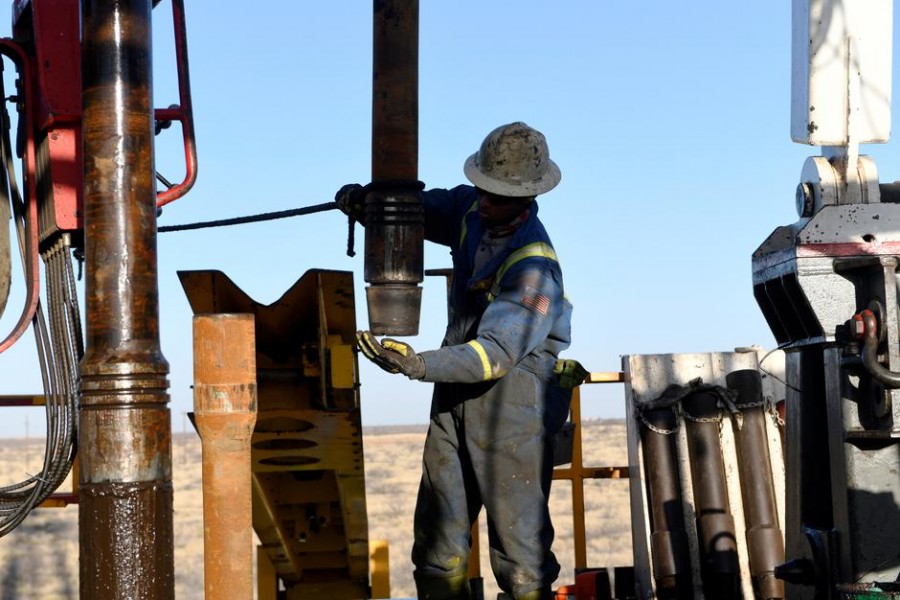 An oil worker removes a thread cap from a piece of drill pipe on a drilling lease owned by Elevation Resources near Midland, Texas, US, February 12, 2019 — Reuters/Files