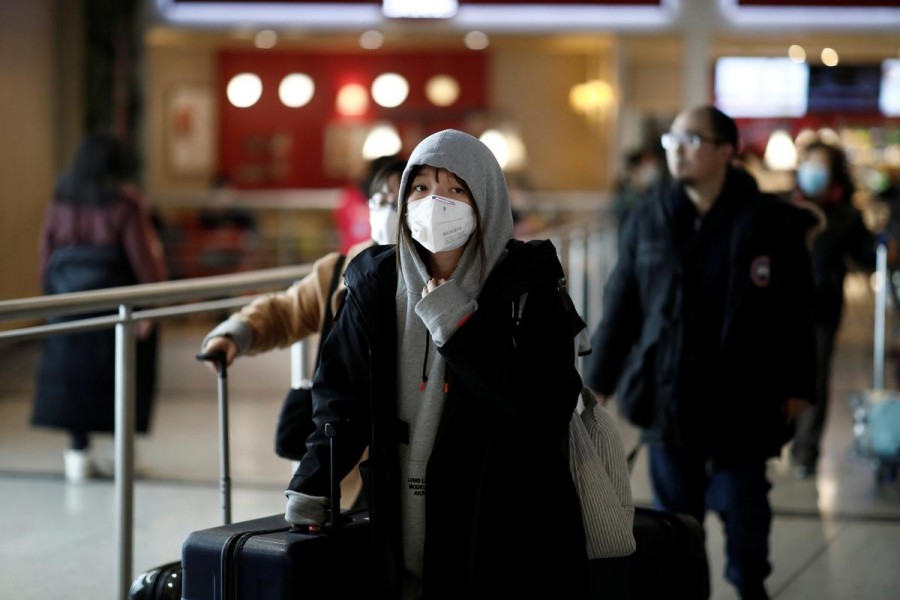 Representational image: Tourists from an Air China flight from Beijing wear protective masks as they arrive at Charles de Gaulle airport in Paris, France, January 26, 2020 — Reuters/Files