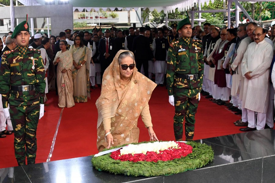 Prime minister Sheikh Hasina placing a wreath at the portrait of father of the nation Bangabandhu Sheikh Mujibur Rahman at Dhanmondi in the city today (Tuesday) marking the great leader's birth centenary. — PID