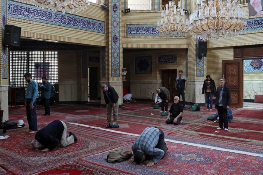Iranian worshippers pray individually at a mosque, following the outbreak of coronavirus, in Tehran, Iran Mar 17, 2020. REUTERS