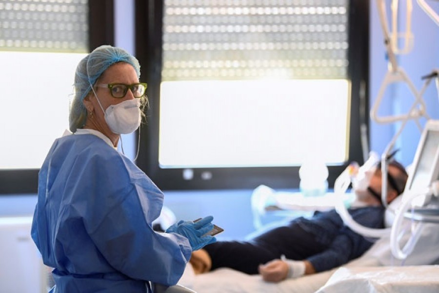 A medical worker wearing a protective mask and suit looks on as she treats a patient suffering from coronavirus disease (COVID-19) in an intensive care unit at the Oglio Po hospital in Cremona, Italy March 19, 2020. — Reuters