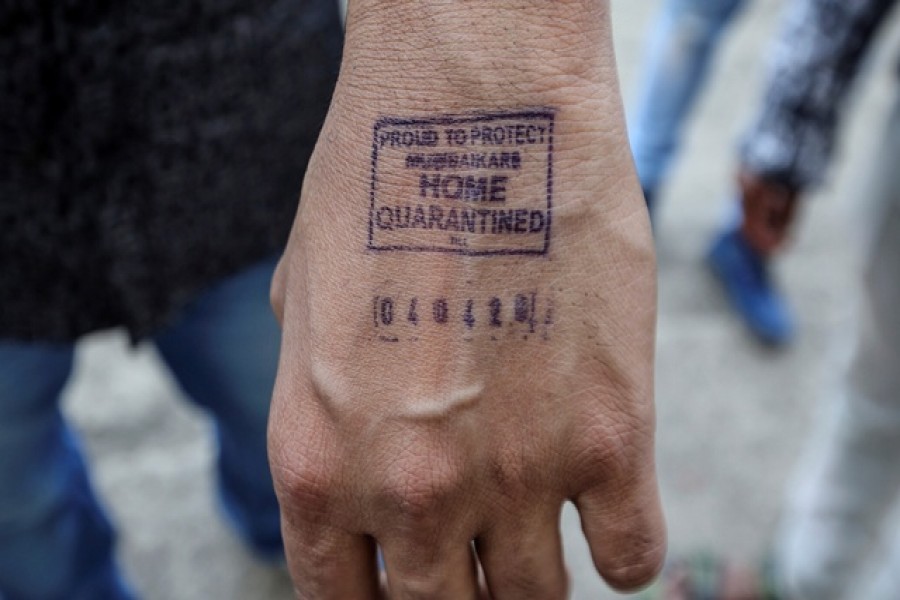 A man shows his hand which was stamped by airport authorities as he was advised for home quarantine after he arrived from overseas, amid coronavirus disease (COVID-19) fears, in Mumbai, India, March 21, 2020. — Reuters