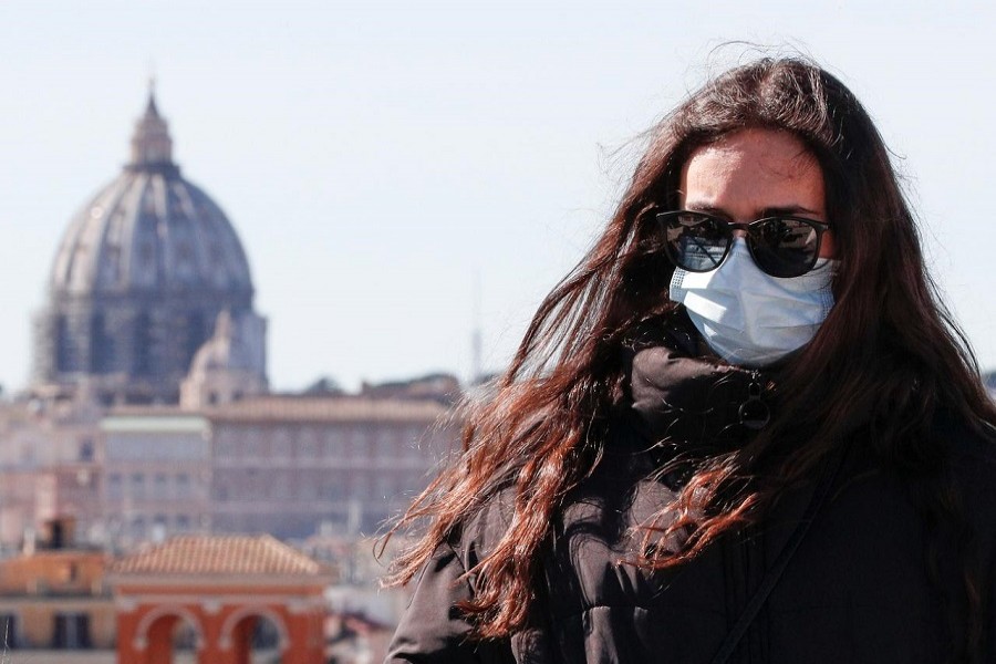 A woman wears a protective mask in downtown Rome, Italy, February 28, 2020. — Reuters/Files