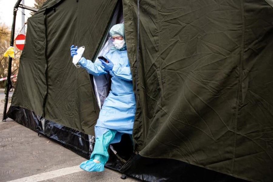 A doctor in protective suite leaves a special tent for coronavirus disease cases near a hospital in Lublin, Poland on March 23, 2020 — Reuters photo