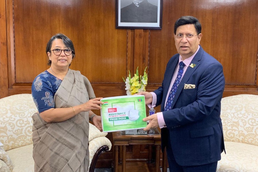 Indian high commissioner Riva Ganguly Das handing over an assistance in form of masks and head-covers to Bangladesh foreign minister AK Abdul Momen in the city on Wednesday.