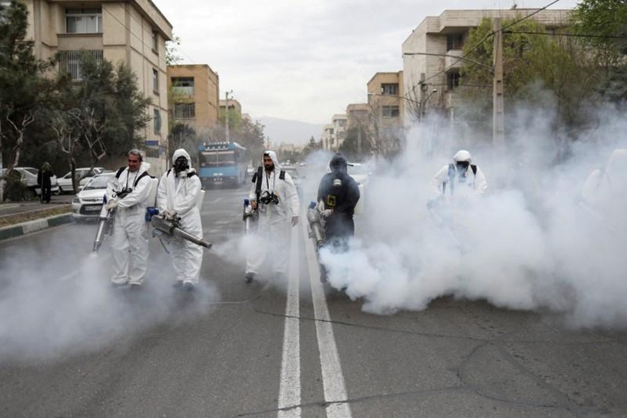 Members of firefighters wear protective face masks, amid fear of coronavirus disease (COVID-19), as they disinfect the streets, ahead of the Iranian New Year Nowruz, March 20, in Tehran, Iran on March 18, 2020 — Reuters/Files