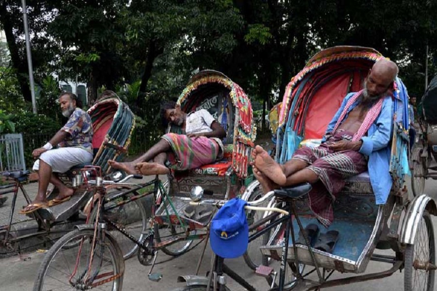 Three rickshaw-pullers taking rest at an unspecified location in the city on June 26, 2018, when the summer heat is at its peak. — UNB/Files