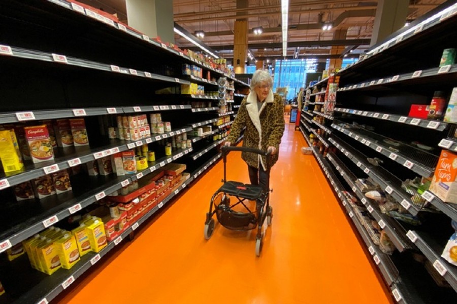 A shopper walks through an aisle empty of pasta, rice, beans and soup at a Loblaws supermarket in Toronto, Ontario, Canada, March 14, 2020. — Reuters/Files