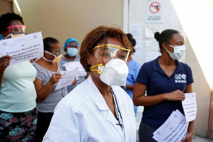 Medical staff display signs after the director of the hospital, surgeon Jerry Bitar, was kidnapped, as Haiti battles an outbreak of the coronavirus disease (COVID-19) amid a spike in gang violence, in Port-au-Prince, Haiti on March 27, 2020 — Reuters photo