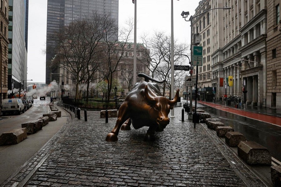 The Wall St. Bull is seen standing on a nearly empty Broadway in the financial district, as the coronavirus disease (COVID-19) outbreak continues, in New York City, New York, US, March 23, 2020. —Reuters