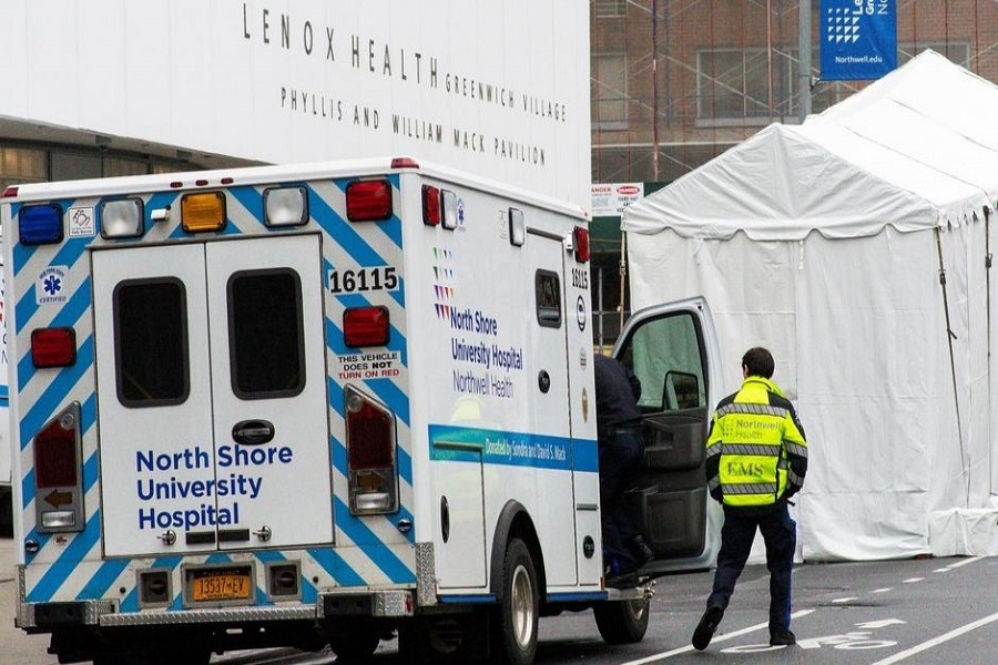 A paramedic walks next to a makeshift morgue set outside Lenox Health Medical Pavilion as the coronavirus disease (COVID-19) outbreak continues in New York, US, March 29, 2020. — Reuters