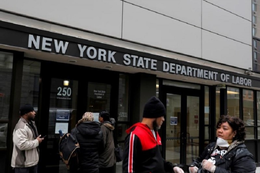 People gather at the entrance for the New York State Department of Labor offices, which closed to the public due to the coronavirus disease (COVID-19) outbreak in the Brooklyn borough of New York City, US, March 20, 2020. — Reuters/Files