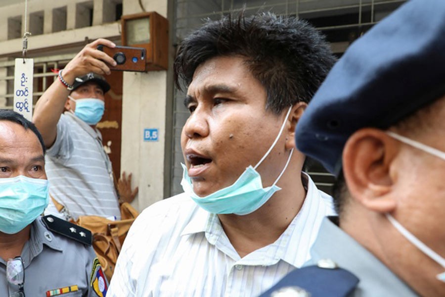 Nay Myo Lin, the editor-in-chief of Voice of Myanmar, is escorted by the police to court in Mandalay, Myanmar on Tuesday. –Reuters Photo